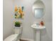 Small bathroom with pedestal sink, toilet, and oval mirror at 13014 Bayberry Way, Parrish, FL 34219