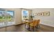 Dining area with glass table, yellow chairs, and access to backyard at 13014 Bayberry Way, Parrish, FL 34219