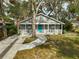 House with teal door, walkway, and well-manicured lawn at 1335 12Th St, Sarasota, FL 34236