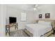 Comfortable bedroom with a neutral-toned bed, a TV stand, and a patterned rug at 1335 12Th St, Sarasota, FL 34236