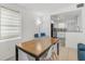 Bright dining area with a wooden table, white chairs, and view into kitchen at 1335 12Th St, Sarasota, FL 34236