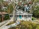 Gray house with teal door, front porch, and landscaped yard at 1335 12Th St, Sarasota, FL 34236