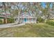 Charming gray house with a bright blue door and a well-maintained lawn at 1335 12Th St, Sarasota, FL 34236