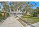 Newly renovated home with a gray exterior, teal door, and a large front yard at 1335 12Th St, Sarasota, FL 34236