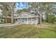 Gray house with white trim, teal door, and a spacious front yard at 1335 12Th St, Sarasota, FL 34236