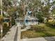 Gray house with teal door, front porch, and landscaped yard at 1335 12Th St, Sarasota, FL 34236