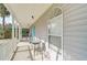 Quaint front porch with white railings, a small table and chairs, and a view of the street at 1335 12Th St, Sarasota, FL 34236