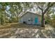 House back view shows gray siding, a teal door, and a yard at 1335 12Th St, Sarasota, FL 34236