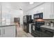 Modern kitchen with black appliances, white cabinets, and granite countertops at 1335 12Th St, Sarasota, FL 34236