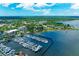 Aerial view of waterfront condo building with marina and city skyline in background at 1510 1St W Ave # 303, Bradenton, FL 34205