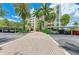 Condo building exterior with palm trees and brick paved driveway at 1510 1St W Ave # 303, Bradenton, FL 34205