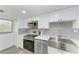 Modern kitchen with stainless steel appliances and a farmhouse sink at 1510 1St W Ave # 303, Bradenton, FL 34205