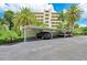 Covered parking with lush landscaping surrounding the building at 1510 1St W Ave # 303, Bradenton, FL 34205