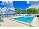 Inviting community pool with lounge chairs and waterfront view at 1510 1St W Ave # 303, Bradenton, FL 34205