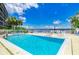 Relaxing pool and spa area with waterfront view and lounge chairs at 1510 1St W Ave # 303, Bradenton, FL 34205