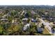 Aerial view of a home nestled among lush trees in a neighborhood with a clear view of the city skyline at 1717 32Nd St, Sarasota, FL 34234