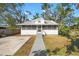 Quaint house featuring a metal roof, screened porch, and a well-maintained lawn at 1717 32Nd St, Sarasota, FL 34234