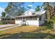 White house with screened porch and grassy yard at 1717 32Nd St, Sarasota, FL 34234