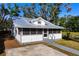 Charming bungalow with metal roof, screened porch, and spacious yard at 1717 32Nd St, Sarasota, FL 34234