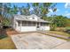 Front view of a charming white house with a screened porch at 1717 32Nd St, Sarasota, FL 34234