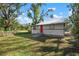 Charming house with a red door and spacious grassy yard at 1717 32Nd St, Sarasota, FL 34234