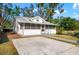 Charming single-story home featuring a screened-in porch and concrete driveway, creating an inviting curb appeal at 1717 32Nd St, Sarasota, FL 34234