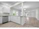 Open concept kitchen with white cabinets and a view into the living room at 1717 32Nd St, Sarasota, FL 34234