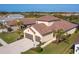 Aerial view of a single-Gathering home with a two-car garage and tile roof at 1748 Still River Dr, Venice, FL 34293