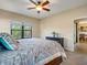 Spacious bedroom with king-size bed and access to bathroom at 1748 Still River Dr, Venice, FL 34293