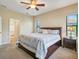 King-size bedroom with ceiling fan and ensuite bathroom at 1748 Still River Dr, Venice, FL 34293