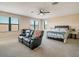 Main bedroom with a king-size bed and a leather recliner at 1748 Still River Dr, Venice, FL 34293