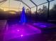 Night view of a relaxing pool and spa with colorful LED lighting at 1748 Still River Dr, Venice, FL 34293