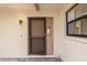 Condo entry with a brown security door and a light pink front door at 1767 Lake Pl # 1767A, Venice, FL 34293