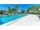 Inviting community pool with lounge chairs and umbrellas at 1767 Lake Pl # 1767A, Venice, FL 34293