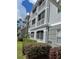 Gray building exterior with balconies and landscaping at 18001 Richmond Place Dr # 1222, Tampa, FL 33647