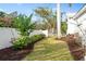 Landscaped backyard with gate entry and mature plantings at 1810 Wisteria St, Sarasota, FL 34239