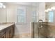 Bathroom with granite countertop, wood cabinets and glass shower at 1810 Wisteria St, Sarasota, FL 34239