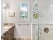 Bathroom boasts granite vanity and a glass shower at 1810 Wisteria St, Sarasota, FL 34239