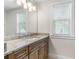 Bathroom with granite countertop, wood cabinets and a large mirror at 1810 Wisteria St, Sarasota, FL 34239