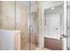 Bathroom with glass shower and view into another room at 1810 Wisteria St, Sarasota, FL 34239