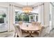 Bright dining room with round table, chandelier, and pool view at 1810 Wisteria St, Sarasota, FL 34239