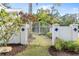 Attractive entry gate with white fence and landscaping at 1810 Wisteria St, Sarasota, FL 34239