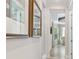 Bright hallway with framed art leading to living area at 1810 Wisteria St, Sarasota, FL 34239