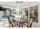 Outdoor dining area with glass table and chairs, view of pool at 1810 Wisteria St, Sarasota, FL 34239