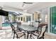 Outdoor dining area with glass table and chairs, view of pool at 1810 Wisteria St, Sarasota, FL 34239