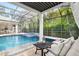 Relaxing poolside seating with a waterfall feature at 1810 Wisteria St, Sarasota, FL 34239