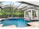 Enclosed pool area with spa and waterfall feature at 1810 Wisteria St, Sarasota, FL 34239