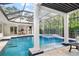 Pool and spa with covered patio and waterfall at 1810 Wisteria St, Sarasota, FL 34239