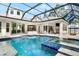 Inviting pool and spa with covered patio, outdoor kitchen, and fire pit at 1810 Wisteria St, Sarasota, FL 34239