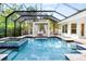 Lush pool and spa area with covered pergola and seating at 1810 Wisteria St, Sarasota, FL 34239